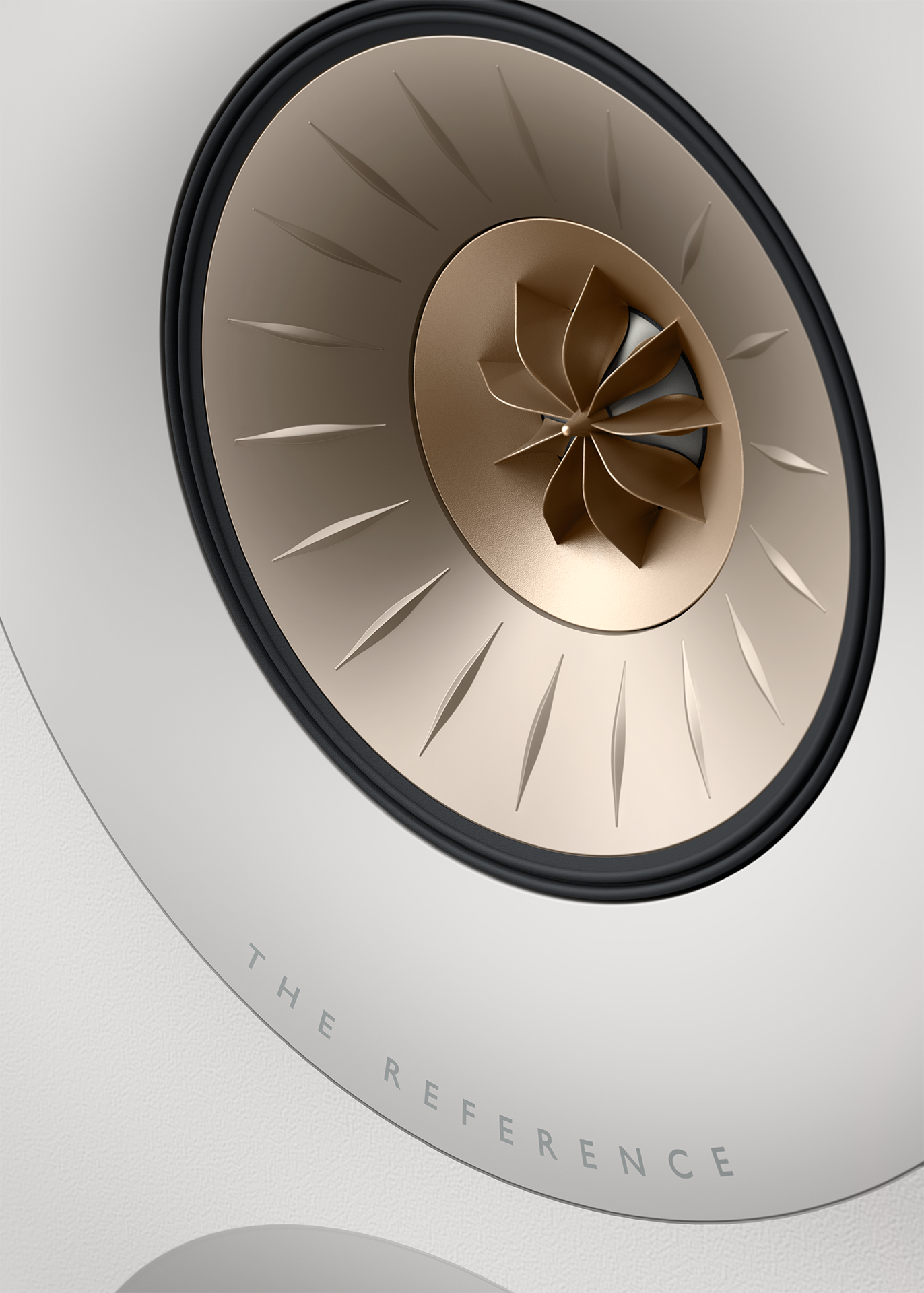 Close-up of a high-end speaker with 'The Reference' branding on a light gray background